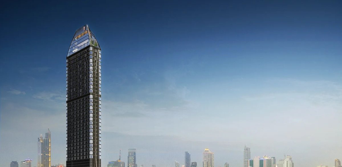 Park Origin Chula-Samyan tower at dusk above the Bangkok skyline