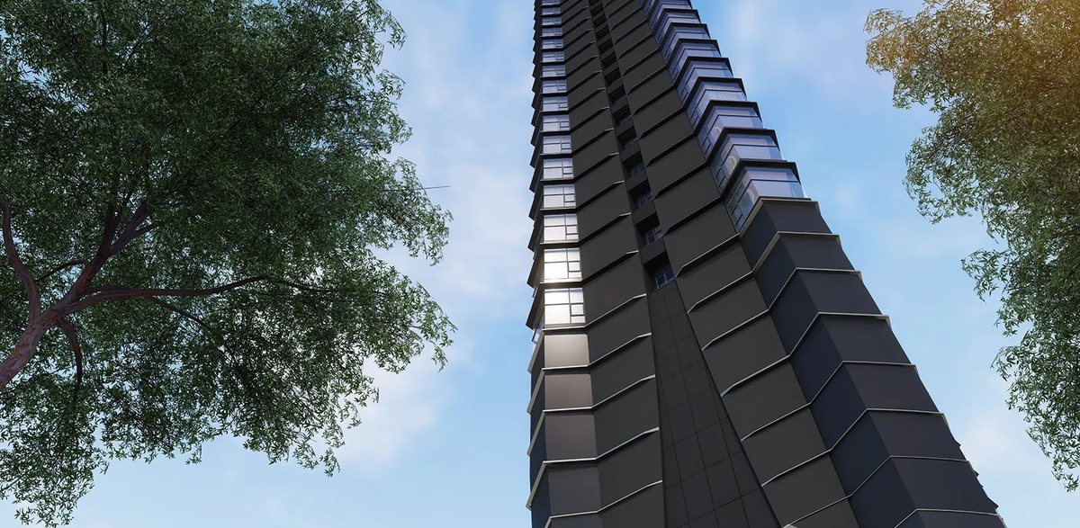 The tower facade rising above the trees